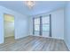 Spacious bedroom featuring wood-look floors and large windows at 19462 Paddock View Dr, Tampa, FL 33647