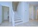 Modern staircase with white railings and wood steps at 19462 Paddock View Dr, Tampa, FL 33647