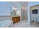 Bathroom with walk-in shower, granite vanity, and separate toilet area at 19462 Paddock View Dr, Tampa, FL 33647