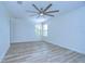 Bright bedroom with wood-look floors and ceiling fan at 19462 Paddock View Dr, Tampa, FL 33647
