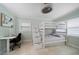 Bright bedroom with bunk beds, a workspace, and large windows at 245 78Th N Ave, St Petersburg, FL 33702