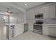 Modern kitchen with stainless steel appliances and island at 6950 Towering Spruce Dr, Riverview, FL 33578