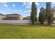 Landscaped backyard with a white fence and green lawn at 6950 Towering Spruce Dr, Riverview, FL 33578