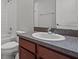 Bathroom with single vanity, brown cabinets, and white tile at 6950 Towering Spruce Dr, Riverview, FL 33578