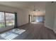 Spacious living room featuring light grey vinyl flooring and plenty of natural light at 3845 Sailmaker Ln, Holiday, FL 34691