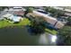 Aerial view of community featuring lake, pool, and numerous buildings at 3845 Sailmaker Ln, Holiday, FL 34691