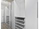 Large walk-in closet with mirrored doors and drawers at 19433 Whispering Brook Dr, Tampa, FL 33647