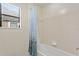 Clean bathroom with shower/tub combo and patterned shower curtain at 19433 Whispering Brook Dr, Tampa, FL 33647