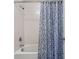 Clean bathroom with shower/tub combo and patterned shower curtain at 19433 Whispering Brook Dr, Tampa, FL 33647