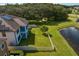Aerial view of home with fenced backyard, pond, and solar panels at 19433 Whispering Brook Dr, Tampa, FL 33647