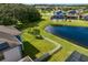 Aerial view showcasing a house's backyard, lake, and neighborhood at 19433 Whispering Brook Dr, Tampa, FL 33647