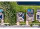 Aerial view of homes with solar panels and a lake at 19433 Whispering Brook Dr, Tampa, FL 33647