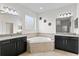 Main bathroom with corner tub and dark wood cabinets at 19433 Whispering Brook Dr, Tampa, FL 33647