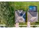 Aerial view of two houses with solar panels and a pool at 19433 Whispering Brook Dr, Tampa, FL 33647