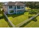 Two story home with fenced backyard, featuring a large grassy area at 19433 Whispering Brook Dr, Tampa, FL 33647