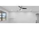 Spacious living room with large window and ceiling fan at 19433 Whispering Brook Dr, Tampa, FL 33647