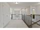 Upstairs hallway with neutral carpeting and iron railings at 19433 Whispering Brook Dr, Tampa, FL 33647
