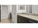 Clean bathroom with dark vanity, granite countertop, and single sink at 19433 Whispering Brook Dr, Tampa, FL 33647