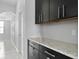 Kitchen features dark cabinetry and granite countertops at 19433 Whispering Brook Dr, Tampa, FL 33647