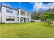 Spacious backyard with a large grassy area and a white fence at 19433 Whispering Brook Dr, Tampa, FL 33647