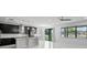 Modern kitchen with dark cabinetry, granite island, and pendant lighting at 19433 Whispering Brook Dr, Tampa, FL 33647