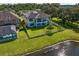 Aerial view of a house with fenced backyard and lake view at 19433 Whispering Brook Dr, Tampa, FL 33647