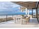 Beachfront balcony with outdoor dining set and ocean views at 10126 Gulf Blvd # Ph1, Treasure Island, FL 33706