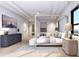 Main bedroom with four-poster bed, ample light, and ocean view at 10126 Gulf Blvd # Ph1, Treasure Island, FL 33706