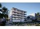 Modern building exterior near beach with palm trees at 10126 Gulf Blvd # Ph1, Treasure Island, FL 33706