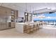 Modern kitchen with marble island, stainless steel appliances, and ocean view at 10126 Gulf Blvd # Ph1, Treasure Island, FL 33706