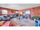 Cozy living room featuring a sectional sofa and terracotta walls at 5614 17Th S Ave, Gulfport, FL 33707