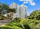 Exterior of building showcasing landscaping and waterfront location at 220 Belleview Blvd # 702, Belleair, FL 33756