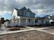 Two-story home with light teal exterior, white trim, and landscaped yard at 3200 19Th N St, St Petersburg, FL 33713