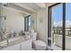 Well-lit bathroom featuring a granite vanity top, new toilet, and balcony with views at 800 S Gulfview Blvd # 903, Clearwater Beach, FL 33767