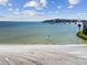 Beautiful beach area with clear blue water and a nearby bridge at 800 S Gulfview Blvd # 903, Clearwater Beach, FL 33767
