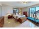Comfortable bedroom featuring a tiled floor, large windows, and an adjacent treadmill for fitness at 800 S Gulfview Blvd # 903, Clearwater Beach, FL 33767