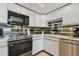 Well-equipped kitchen boasting white cabinetry, stainless steel appliances, and ample counter space at 800 S Gulfview Blvd # 903, Clearwater Beach, FL 33767