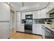 Bright kitchen with white cabinetry, tile floors, and modern appliances, creating a functional cooking space at 800 S Gulfview Blvd # 903, Clearwater Beach, FL 33767