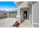 Front entryway with open door and gray siding at 1345 Loveland Blvd, Port Charlotte, FL 33980