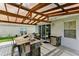 Outdoor kitchen with granite countertop and pergola cover at 6228 Dainty Bess Ct, Land O Lakes, FL 34639