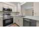 Modern kitchen with stainless steel appliances and white cabinets at 3704 Brigadoon Cir, Clearwater, FL 33759