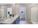 Modern bathroom featuring double sinks and a walk-in shower at 35225 Valley Ridge Rd, Dade City, FL 33525