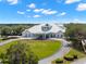 Impressive clubhouse with a metal roof and landscaped grounds at 9295 Butler Blvd, Weeki Wachee, FL 34613