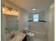 Updated bathroom with white subway tiles, hexagon floor tiles, and a new vanity at 1010 E Flora St, Tampa, FL 33604