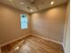 Bright bedroom featuring hardwood floors and a ceiling fan at 1010 E Flora St, Tampa, FL 33604