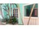 Charming teal building exterior with tropical landscaping and a private entrance at 3002 W Cleveland St # E1, Tampa, FL 33609