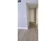 Clean hallway with light grey walls and light wood-look floors at 3002 W Cleveland St # E1, Tampa, FL 33609