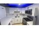 Modern white kitchen with stainless steel appliances and quartz countertops at 3002 W Cleveland St # E1, Tampa, FL 33609