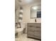 Updated bathroom with gray vanity, white toilet and striped shower curtain at 3002 W Cleveland St # E1, Tampa, FL 33609