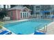 Community pool with a pink pool house and lounge chairs at 3002 W Cleveland St # E1, Tampa, FL 33609